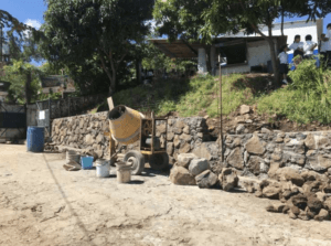 building the base of the wall with stone