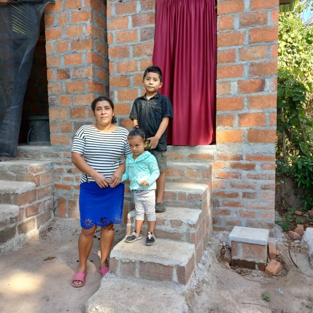 Family in front of new composting latrine