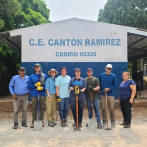 Construction team in front of rural school